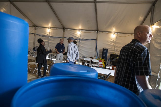 FEMA workers prepare to close a tent in Callaway, Florida in anticipation of inclement weather on Thursday, November 1, 2018. Those looking to apply for assistance can come back Friday morning. [JOSHUA BOUCHER/THE NEWS HERALD]
