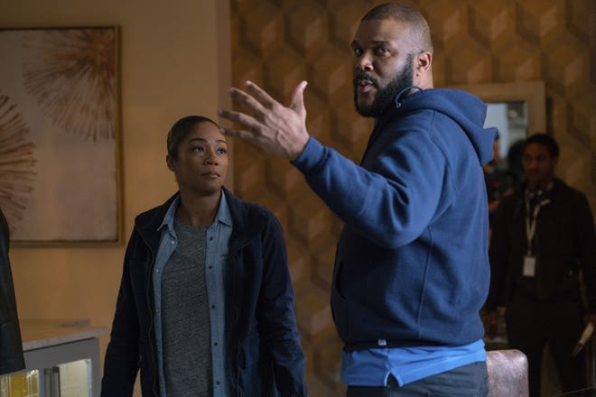 This image released by Paramount Pictures shows director Tyler Perry, right, and Tiffany Haddish on the set of "Nobody's Fool." Haddish has a goal to make 50 movies by her 50th birthday. She says she also wants to keep expectations reasonable adding that ‘they’re not all gonna be great.’ She insists her latest movie, ‘Nobody’s Fool,’ written, directed and produced by Perry is one of the good ones. (Chip Bergmann/Paramount Pictures via AP)