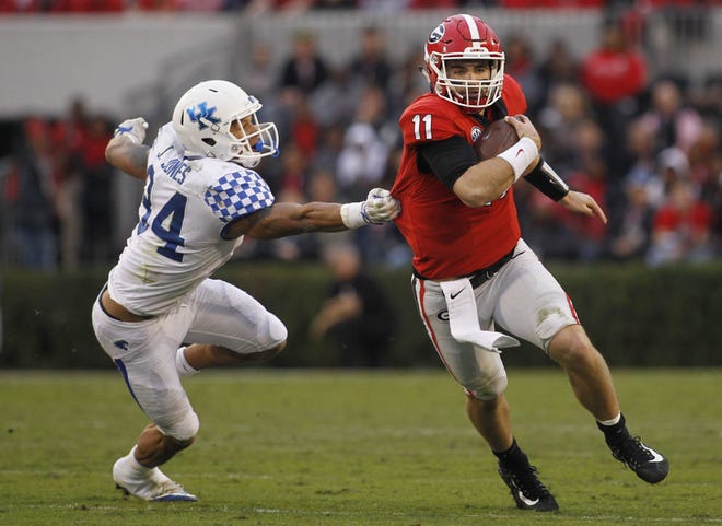 Georgia quarterback Jake Fromm (11) runs the ball as Kentucky linebacker Jordan Jones (34) loses his grip on Fromm's jersey during the first half of a college football game between Georgia and Kentucky at Sanford Stadium, on Saturday, Nov. 18, 2017. (Photo/Casey Sykes, www.caseysykes.com)