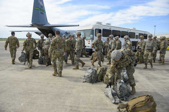 Soldiers from the 89th Military Police Brigade, and 41st Engineering Company, 19th Engineering Battalion, Fort Riley, Kan., arrive at Valley International Airport, in Harlingen, Texas, Thursday, as part of the U.S.-Mexico border buildup. Area support is coming from Fort Carson and Peterson Air Force Base. [ALEXANDRA MINOR/U.S. AIR FORCE VIA AP]