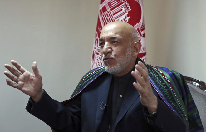 Former Afghan President Hamid Karzai speaks during an interview with The Associated Press in Kabul, Afghanistan, Thursday, Nov. 1, 2018. Karzai said Thursday that he sees a role for the Taliban in his country after the war -- in a future, peaceful Afghanistan. Karzai also said that five Taliban leaders who were freed from the U.S. military prison at Guantanamo Bay in exchange for American army Sgt. Bowe Bergdahl are “good individuals, good Afghans” who should have a role in peace negotiations. (AP Photo/Rahmat Gul)