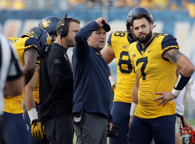 West Virgina quarterback Will Grier (7) and Mountaineers coach Dana Holgorsen (center) come into Austin this weekend in a three-way tie with Texas and Oklahoma atop the Big 12 standings. [RAYMOND THOMPSON/THE ASSOCIATED PRESS]