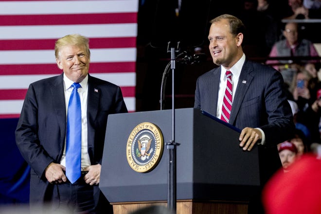 President Donald Trump, left, listens as Rep. Andy Barr, R-Ky., right, speaks at a rally at Alumni Coliseum in Richmond, Ky. The red state is hosting one of the most competitive and expensive races in the country. [AP Photo]