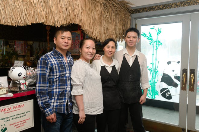 Jon Li (from left) Coco Li, Wendy Tam and Hei Tam stand near the entrance of Panda Panda. Jon and Coco will take over leadership after Tam and Ying, the original owners, decided to retire and move to Hong Kong. Wendy and Hei will stay at the restaurant to help the Li family transition into their new role. [Ben Coley/The Dispatch]