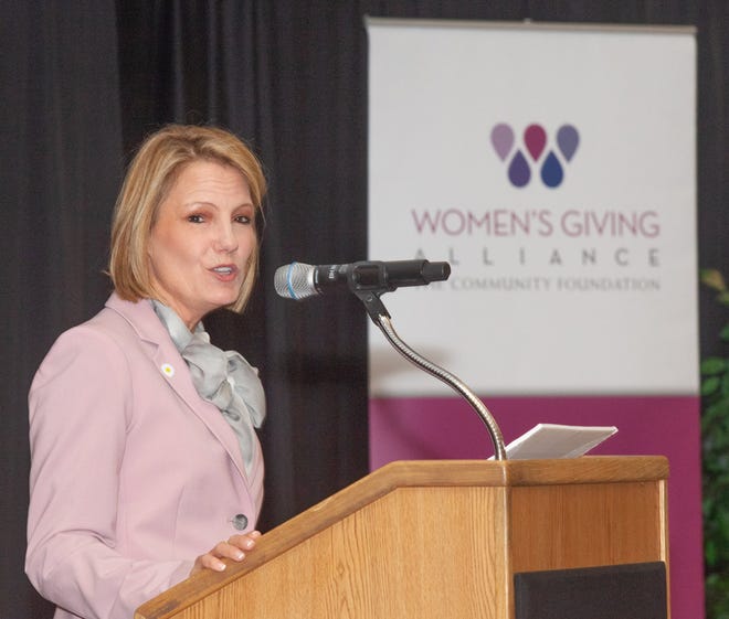 Ellen Wiss, outgoing Women's Giving Alliance president, addresses members at a Wednesday luncheon to announce the group's latest cyle of grants. "What we have accomplished together is wonderful," she said. [Provided by laird/blac palm inc.]