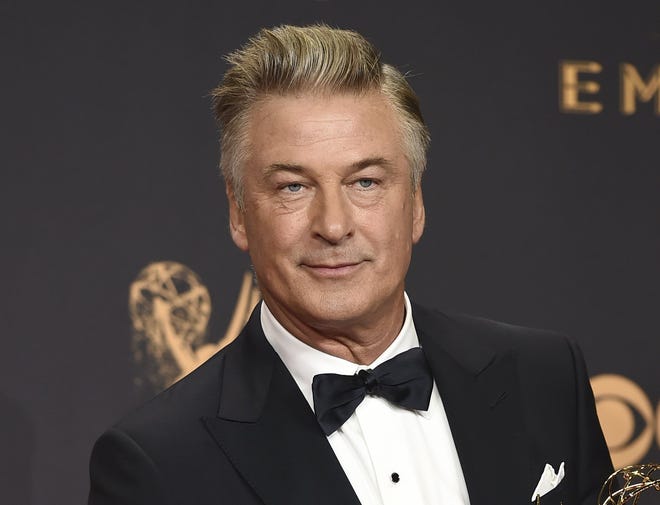 FILE - In this Sept. 17, 2017 file photo, Alec Baldwin poses in the press room with the award for outstanding supporting actor in a comedy series for "Saturday Night Live" at the 69th Primetime Emmy Awards in Los Angeles. Baldwin says voters should see the Nov. 6 midterm elections as an opportunity to peacefully "overthrow the government of Donald Trump." Baldwin spoke Sunday night, Oct. 14, 2018, at a fundraising dinner for the New Hampshire Democratic Party a night after returning to "Saturday Night Live" to portray the president. (Photo by Jordan Strauss/Invision/AP, File)