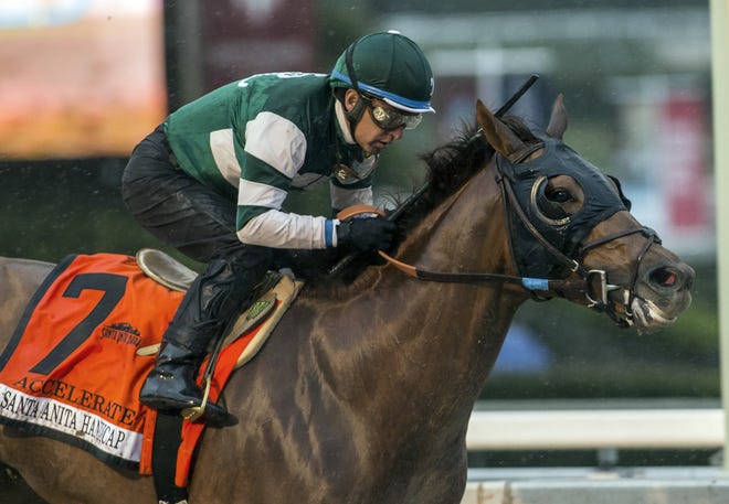 In this March 10, 2018, file photo, provided by Benoit Photo, Accelerate, with Victor Espinoza aboard, wins the Santa Anita Handicap horse race at Santa Anita Park in Arcadia, Calif. Accelerate leads the 14-horse field for the Breeders' Cup Classic, which will offer the 5-year-old a rematch against West Coast in a marquee race that's missing unbeaten Triple Crown winner Justify (Benoit Photo via AP, File)