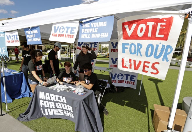 In this Wednesday, Oct. 31, 2018 photo, student volunteers help out at a booth to encourage on campus voting for students during a Vote for Our Lives event at the University of Central Florida in Orlando, Fla. Nine months after 17 classmates and teachers were gunned down at their Florida school, Parkland students are finally facing the moment theyþÄôve been leading up to with marches, school walkouts and voter-registration events throughout the country: their first Election Day. (AP Photo/John Raoux)