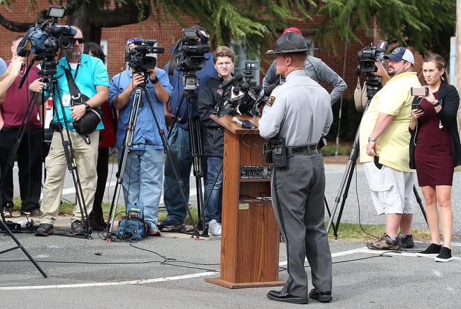 N.C. Highway Patrol Trooper Ray Pierce answers questions from the media about the single car accident Thursday morning on Dallas Bessemer City Highway that took the life of Dallas Police officer Cpl. Travis Wells, a 22 year veteran of the department. [JOHN CLARK/THE GASTON GAZETTE]