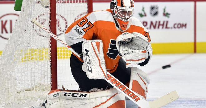 Goalie masks, like the one worn here by the Flyers' Brian Elliott, have evolved since Jacques Plante wore the first mask in 1959, but concussions continue to be a concern for netminders. [AP FILE PHOTO]