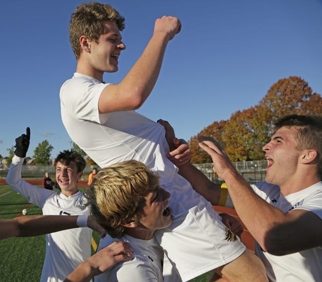 Owen Nettles of New Hope-Solebury celebrates with his teammates after beating Lansdale Catholic 2-1 at Northeast High School Saturday [Kevin Cook / Photojournalist]