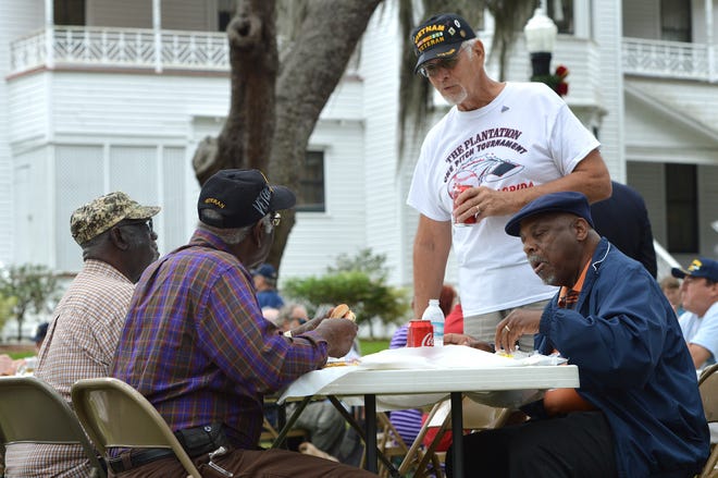Veterans chat during last year's free Veterans Day Cookout hosted by Beyers Funeral Home at the Mote-Morris House in downtown Leesburg. [Whitney Lehnecker/Daily Commercial]