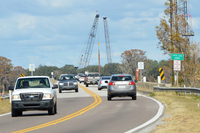 Cars drive on State Road 19 over the existing Little Lake Harris Bridge, which connects Tavares to Howey-in-the-Hills, on Jan. 9. Lake County commissioners will address transportation impact fees at Tuesday's meeting. [Whitney Lehnecker/Daily Commercial]