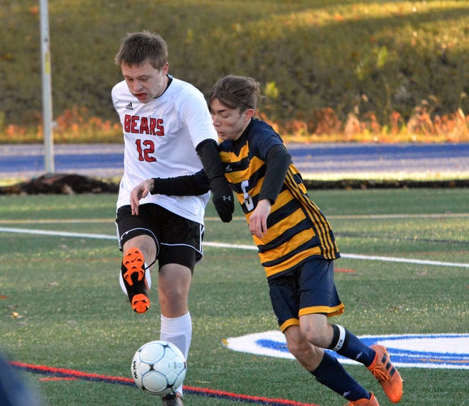 Coe-Brown's Riley Colby, left, clears the ball away from ConVal's Finn Wegmueller during the Division II championship Saturday at SNHU. The Bears lost, 3-2. [Mike Whaley/Fosters.com]
