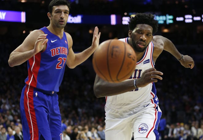 Philadelphia 76ers center Joel Embiid, right, and Detroit Pistons center Zaza Pachulia chase a loose ball. Embiid scored 39 points and added 17 rebounds in the 76ers' 109-99 win. [AP PHOTO/LAURENCE KESTERSON]