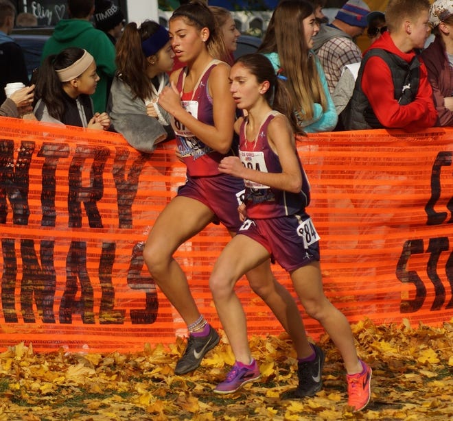 Belvidere North's Madison Diercks, left, and Gianna Sagona charge toward the finish line of Saturday's Class 2A girls state cross country race in Peoria. The pair helped spark the Blue Thunder to the team state championship. [DAN CHAMNESS/RRSTAR.COM CORRESPONDENT]