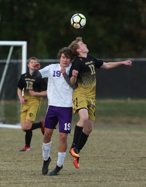 Shelby’s Isaac McMurray battles Ashe County’s Josh Lipscomb for the ball during their first-round playoff game at Shelby High School on Saturday. [Brittany Randolph/The Star]