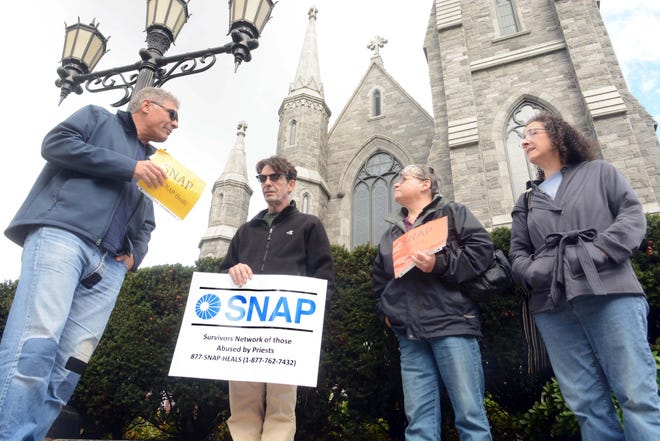 Juan Sosa, of Stamford, left, Tim McGuire, of New London, Nancy Billias, of Manchester, and Agnes Curry, of Simsbury, protest abuse by priests Saturday in front of the Cathedral of St. Patrick in Norwich. See videos at NorwichBulletin.com. [John Shishmanian/ NorwichBulletin.com]