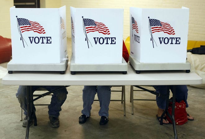 Voters cast their ballots. [John Lovretta/thehawkeye.com]