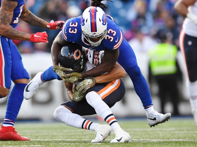 Buffalo Bills' Chris Ivory (33) tackles Chicago Bears' Kyle Fuller (23) after Fuller intercepted a pass during the second half of an NFL football game Sunday, Nov. 4, 2018, in Orchard Park, N.Y. (AP Photo/Adrian Kraus)