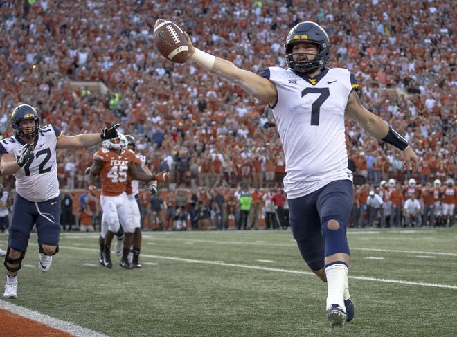 West Virginia quarterback Will Grier (7) scores the game-winning two-point conversion during a college football game against Texas in Austin, Texas, on Saturday. [Photo by AP]