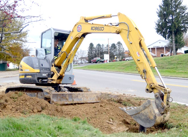 A new water line was put in on North Seventh Street in Byesville recently. Seen here, Mark Parsons of the Village of Byesville uses a mini-excavator to cover the new line Monday afternoon.