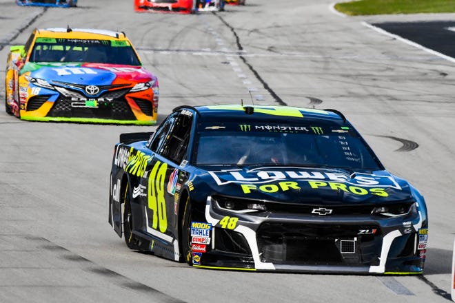 Jimmie Johnson (48) leads Kyle Busch (18) into Turn 1 during Sunday's race at Texas Motor Speedway. [Larry Papke/The Associated Press]