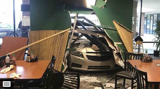 A car drove through the front wall of Mama's Thai Cafe on Sunday, Nov. 4, 2018. [Grand Haven Tribune]