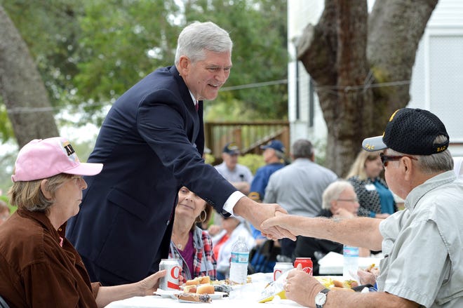 U.S. Rep. Daniel Webster shakes hands with a veteran at the free Veterans Day Cookout hosted by Beyers Funeral Home at the Mote-Morris House in downtown Leesburg on Nov. 10, 2017. Webster won re-election Tuesday. [Whitney Lehnecker/Daily Commercial]
