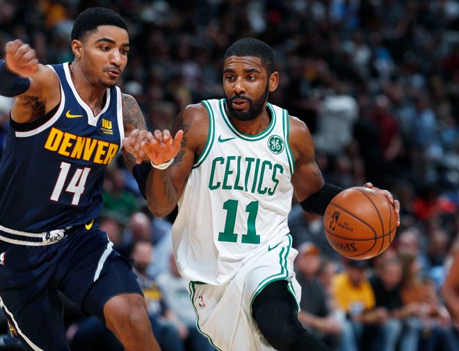Boston Celtics guard Kyrie Irving, right, drives past Denver Nuggets guard Gary Harris to the rim in the second half of an NBA basketball game Monday, Nov. 5, 2018, in Denver. The Nuggets won 115-107. (AP Photo/David Zalubowski)