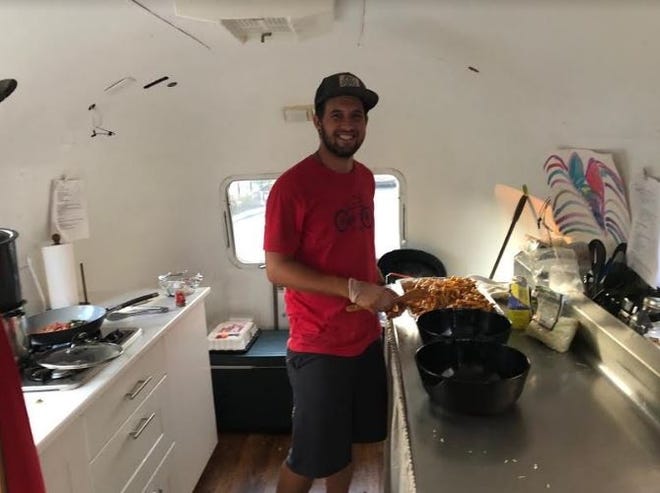 Hunter Davis, seen in his Airstream's kitchen, hopes to become a traveling chef after driving cross-country to cook for a group of cyclists. [CONTRIBUTED PHOTO]