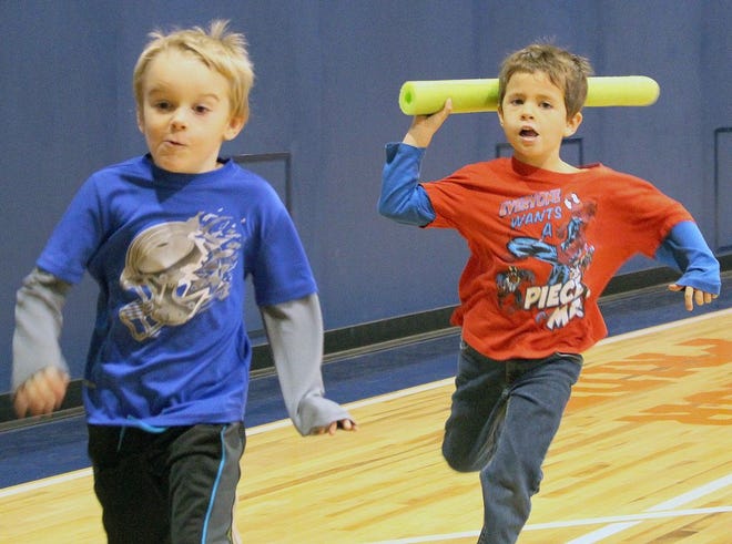 Pierson Alderson, left, chases Dawson Adcock during a game of ocean turtle tag in Central School’s updated gym. Work on the school’s gym floor was recently completed.