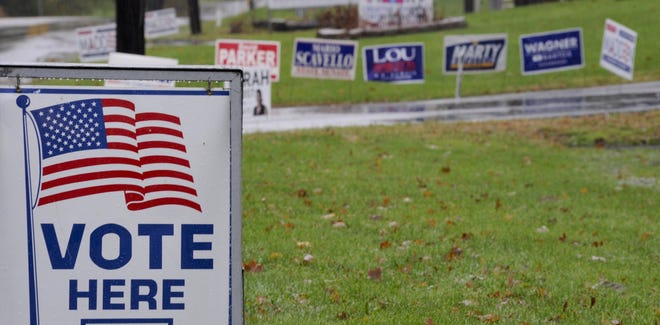 Rain soaked signs dot the lawn outside of the Stroudsburg Weslyan church polling place in Stroud Township on Election Day, Tuesday, November 6, 2018.[KEITH R. STEVENSON/POCONO RECORD]