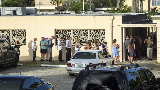 Voters line up outside the First Lutheran Church in West Palm Beach at 7:40 am on Election Day. [LANNIS WATERS/palmbeachpost.com]