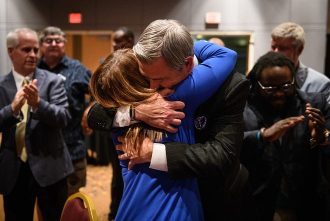 Kirk deViere hugs his wife, Jenny, after narrowly defeating Sen. Wesley Meredith on Tuesday. [Andrew Craft/The Fayetteville Observer]