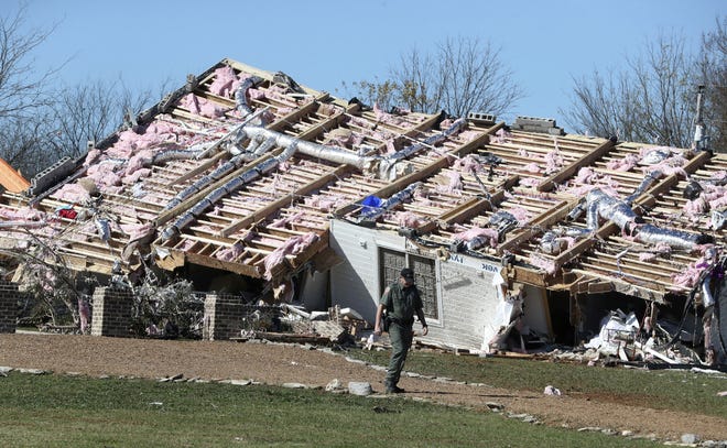 A home rests on its side Tuesday, Nov. 6, 2018, after a deadly tornado blew the house off its foundation in Christiana, Tenn. [Helen Comer/The Tennessean via AP]