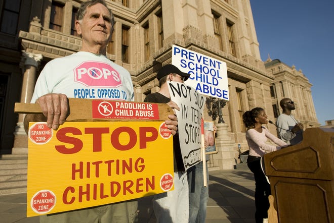 Anti-corporal punishment in school protesters hold up signs at the Texas Capitol in 2010. Now the American Academy of Pediatrics has strengthened its policy against spanking in the home. [Jay Janner/American-Statesman]
