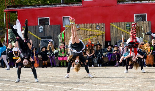 Gymnasts from TGS Gymnastics perform at the Caboose in downtown Alliance during the ever popular Zombiefest Oct. 21, 2017.