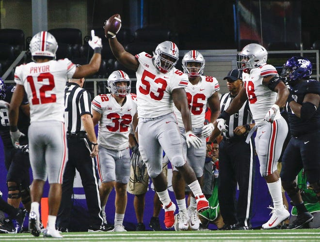 Ohio State Buckeyes defensive tackle Davon Hamilton (53) celebrates after recovering a fumble in the end zone from TCU Horned Frogs quarterback Shawn Robinson, not pictured, during the first quarter of a NCAA Division I college football game between the TCU Horned Frogs and the Ohio State Buckeyes on Saturday, September 15, 2018 at AT&T Stadium in Arlington, Texas. [Joshua A. Bickel]