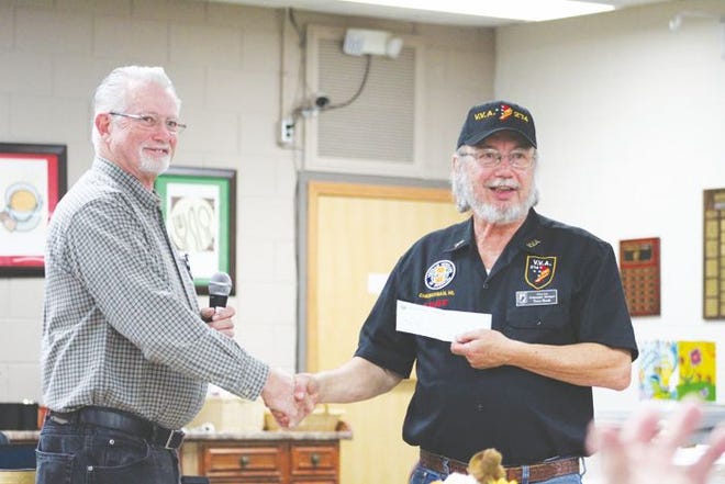 Jim Boyer, Cheboygan Kiwanis President, presented Tracy Heath of the Vietnam Veterans of America Chapter 274 with a check for $1,200 to help fund the Toys for Kids program run by the veterans.