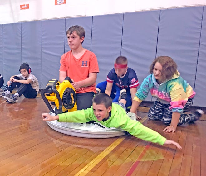 Chloe Woofter, Gage Bowling, Charlie Mowery and Grant Schag get ready for takeoff on their hovercraft. Their sixth-grade class at Wooster Township Elementary designed and built hovercrafts on Halloween.