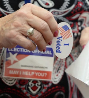 Poll worker Marianne Giovanoni, at the Bridgewater Middle School in Bridgewater on Tuesday, Nov. 6, 2018. (Marc Vasconcellos/The Enterprise)