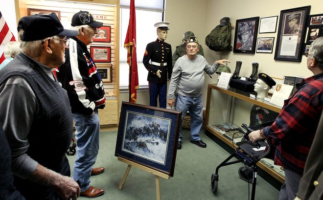 James Mayo, center, leads a group of veterans on a tour of the American Legion Post 23 Military Museum inside Memorial Hall on Second Avenue in Gastonia Wednesday afternoon. [JOHN CLARK/THE GASTON GAZETTE]