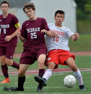 Holliston's Patrick Mejia, right, and Dehdam's Antonio Cucinotta tangle up in pursuit of the ball during the first half of a game played earlier this season. Mejia scored a goal in the Panthers 3-1 Division 3 South quarterfinal win over Scituate on Wednesday. [Daily News Staff File Photo/Ken McGagh]