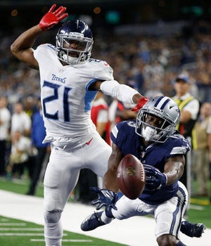Dallas Cowboys wide receiver Michael Gallup (13) stretches for the ball as Tennessee Titans cornerback Malcolm Butler (21) defends during the second half of an NFL football game, Monday, Nov. 5, 2018, in Arlington, Texas.
