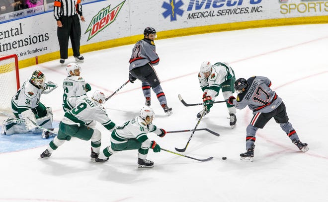 Rockford's Terry Broadhurst takes a shot amid several Iowa Wild players during Wednesday's AHL hockey game, the first for Derek King as the IceHogs' head coach. [PHOTO PROVIDED BY THE ROCKFORD ICEHOGS]