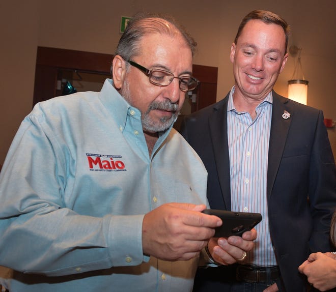 Sarasota County Commission District 2 candidate Al Maio, left, and State House District 73 Republican candidate Tommy Gregory watch results come in during an election party at the Hyatt Regency Sarasota on Tuesday evening. [Herald-Tribune staff photo / Dan Wagner]