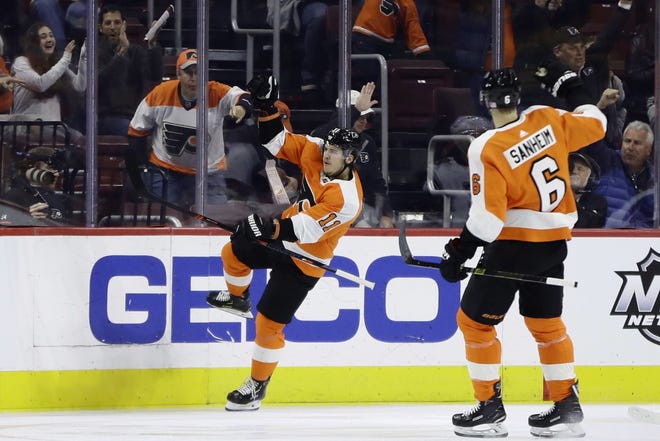 The Flyers' Travis Konecny, left, and Travis Sanheim celebrate after Konecny's goal during the first period of Thursday night's game against the Coyotes. [MATT SLOCUM / The Associated Press]