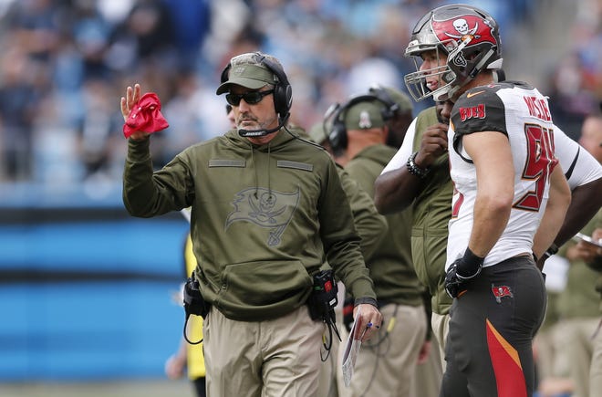 Tampa Bay Buccaneers head coach Dirk Koetter, left, challenges a call during a game against the Carolina Panthers in Charlotte, N.C., on Sunday. [AP Photo/Nell Redmond]