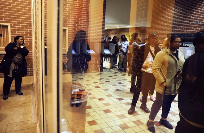 Voters wait in line on election day after an order issued in Fulton County Superior Court ordered the polling location to remain open until 10 p.m., a full three hours after polls closed statewide, in Atlanta, Tuesday, Nov. 6, 2018. (AP Photo/David Goldman)